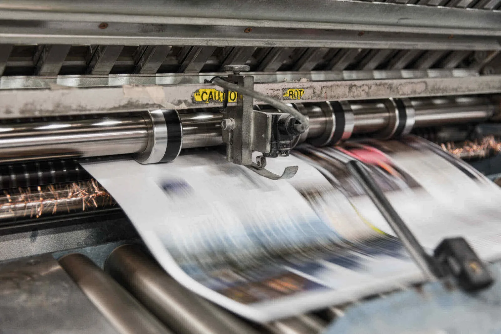 Sheets running at speed through a printing press
